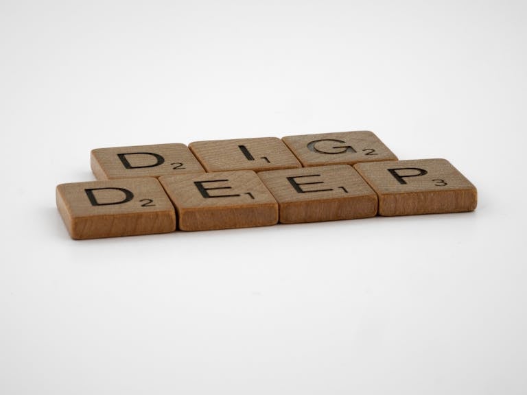 Brown Wooden Scrabble Tiles on White Background